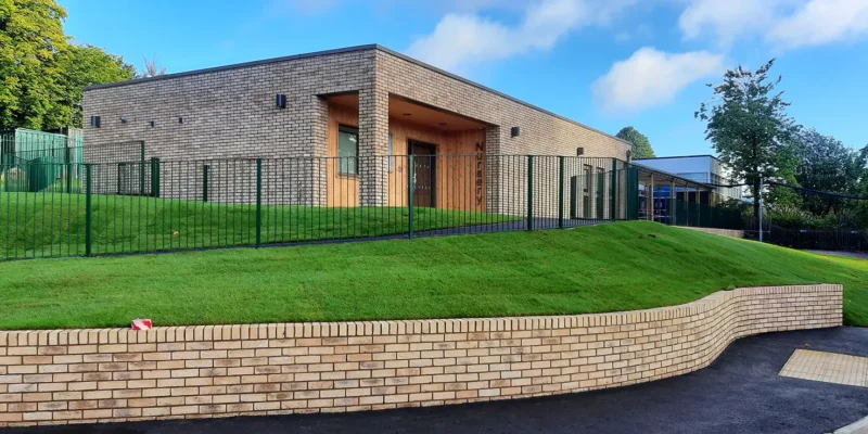 Kings Furlong School External shot including the grass bank